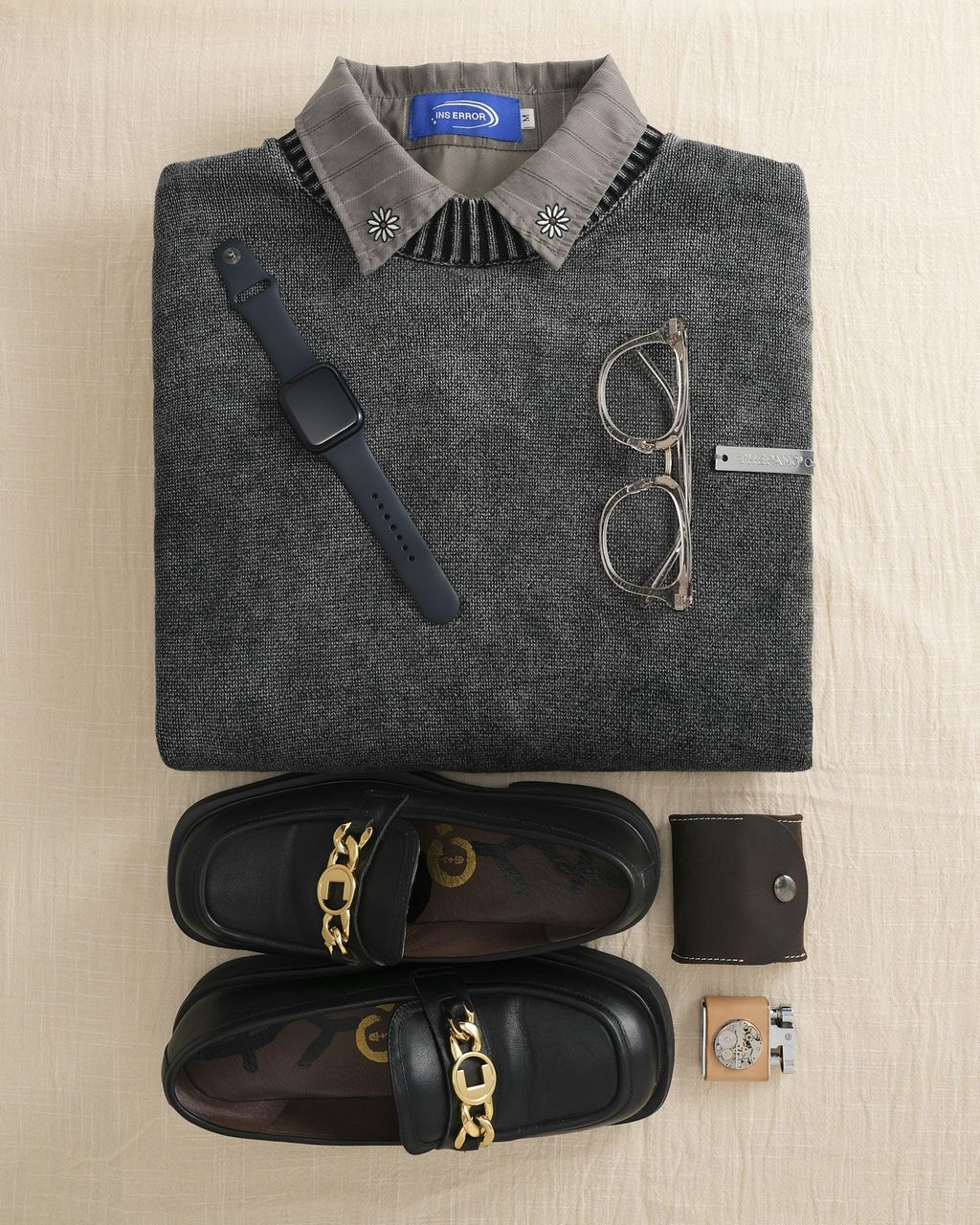 Menswear flat lay with knit sweater and accessories — apparel photography