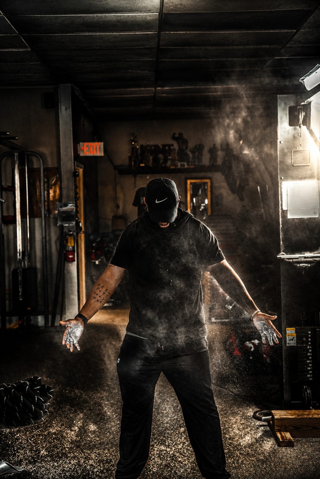 Athlete clapping chalk in a dark gym — fitness photography